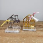 metal house with family on plexiglass base